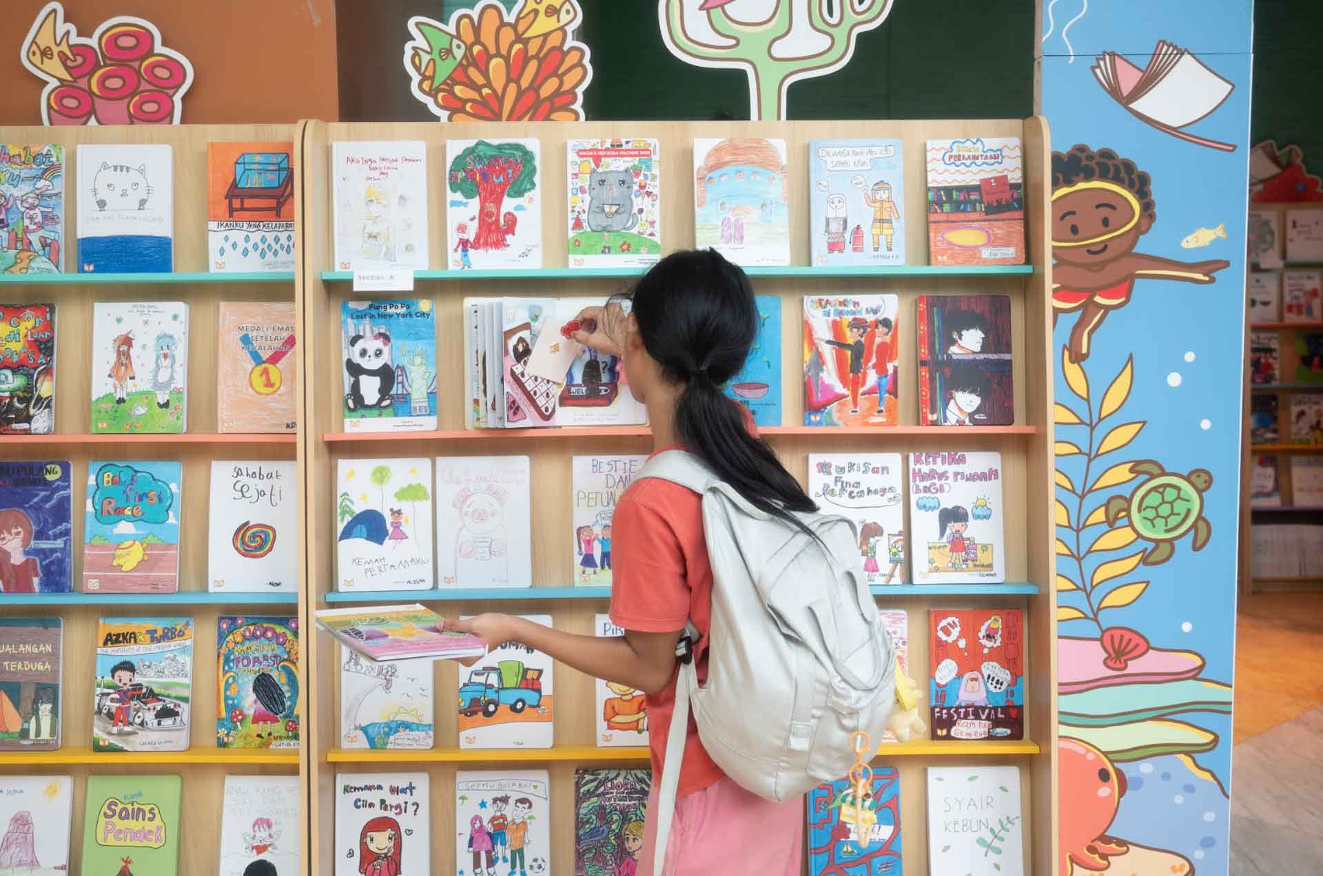 Children showcasing their books at Karya Raya exhibition